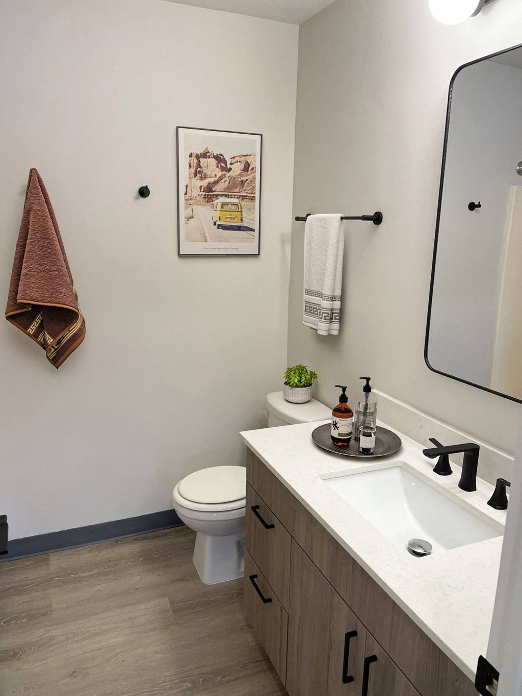 a small bathroom with a toilet sink and mirror